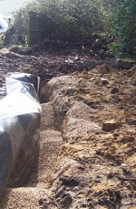 Figure 1, Tree root barrier trench to remediate subsidence. Trench showing use of geo membrane and fill material (M Kawecki)